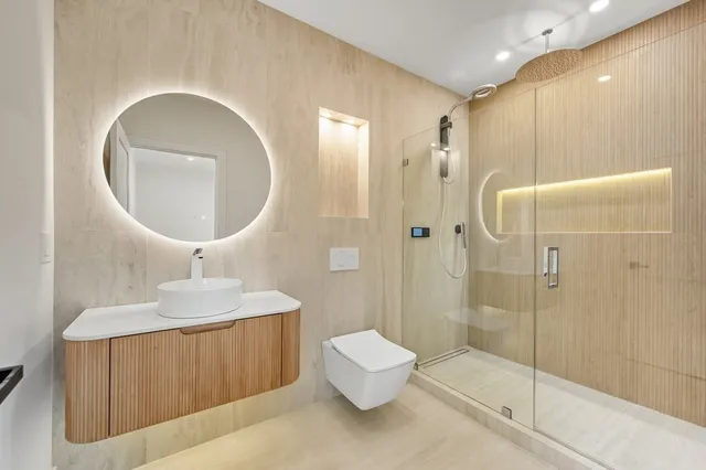 a bathroom with a sink toilet and shower
