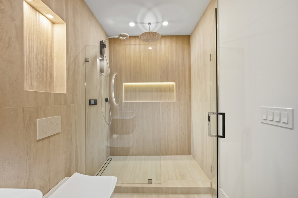 863 Main Street Reading, MA 01867 - Photo 15 of 42 a bathroom with a shower and a mirror