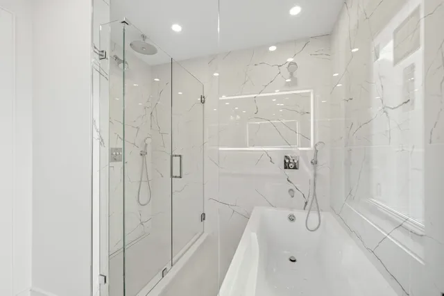 a bathroom with a shower and a glass door