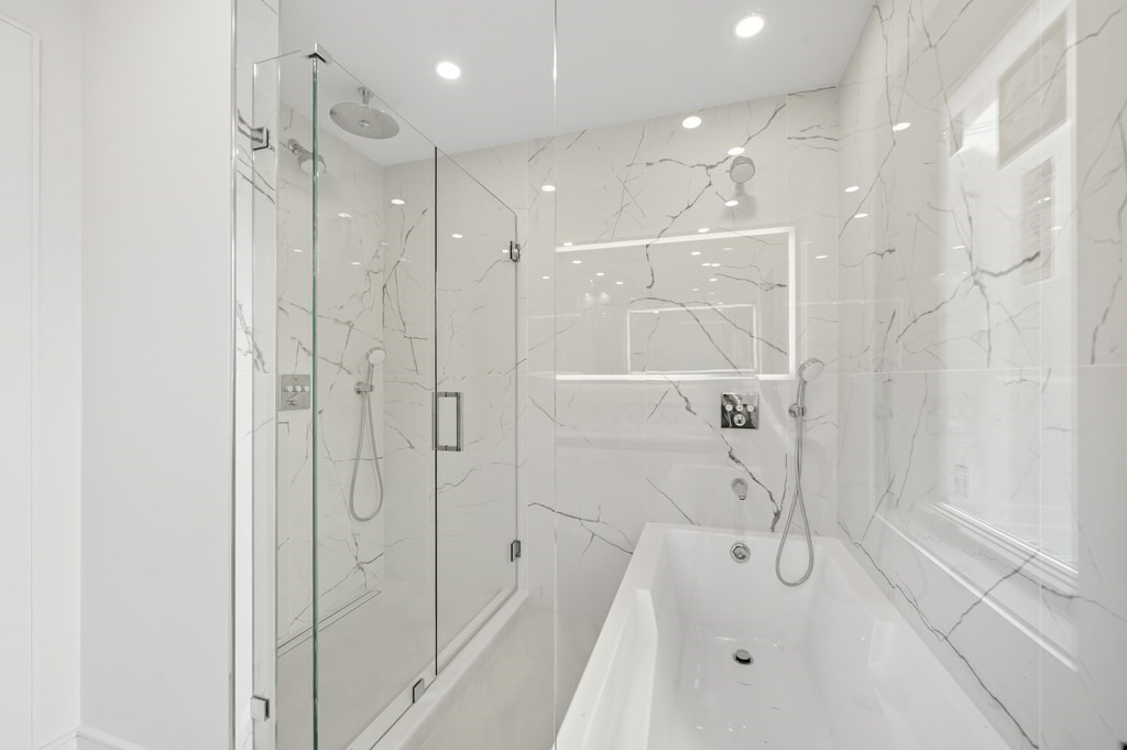 863 Main Street Reading, MA 01867 - Photo 18 of 42 a bathroom with a shower and a glass door