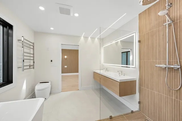 a large kitchen with a large window and stainless steel appliances