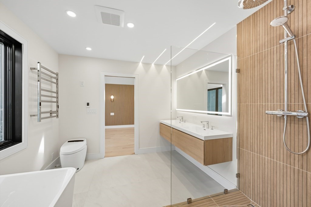 863 Main Street Reading, MA 01867 - Photo 26 of 42 a bathroom with a double vanity sink a toilet and shower