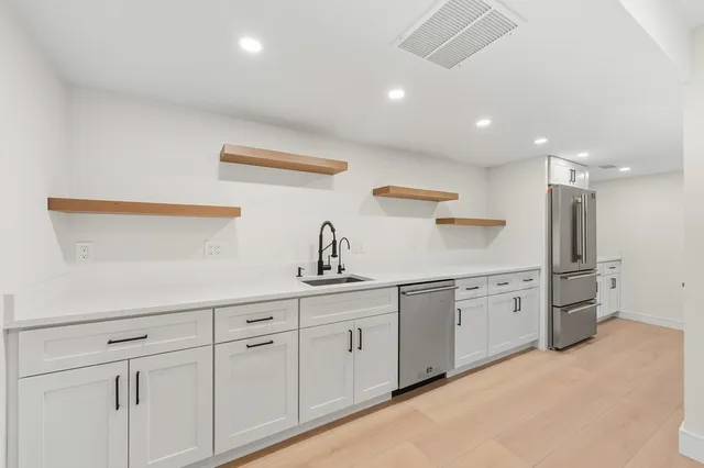 an empty room with windows and closet