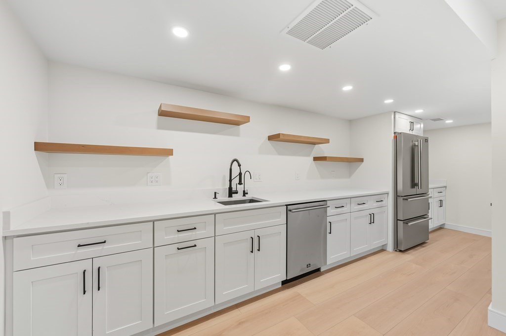 863 Main Street Reading, MA 01867 - Photo 28 of 42 a kitchen with white cabinets