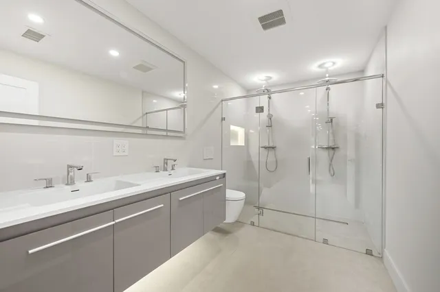 a bathroom with a tub a sink and shower