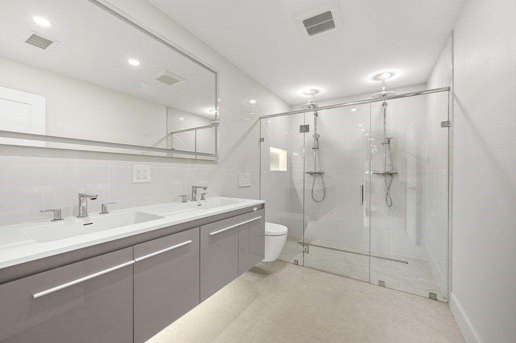 863 Main Street Reading, MA 01867 - Photo 30 of 42 a bathroom with a double vanity sink mirror and shower