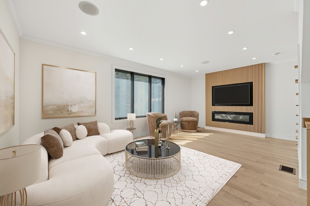 863 Main Street Reading, MA 01867 - Photo 3 of 42 a living room with furniture and a flat screen tv