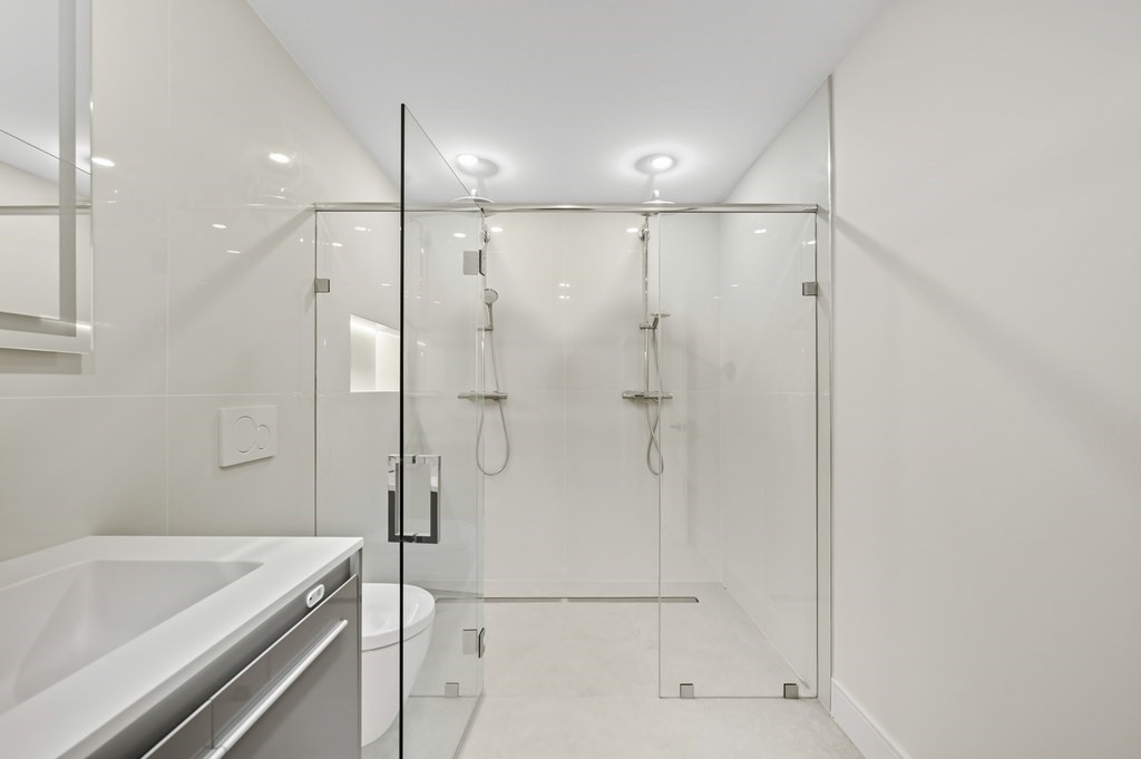 863 Main Street Reading, MA 01867 - Photo 31 of 42 a bathroom with a tub a sink and shower