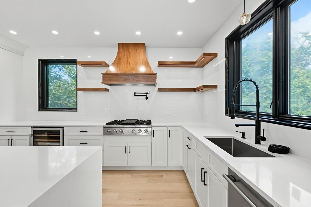 863 Main Street Reading, MA 01867 - Photo 6 of 42 a kitchen with stainless steel appliances a sink stove and a window