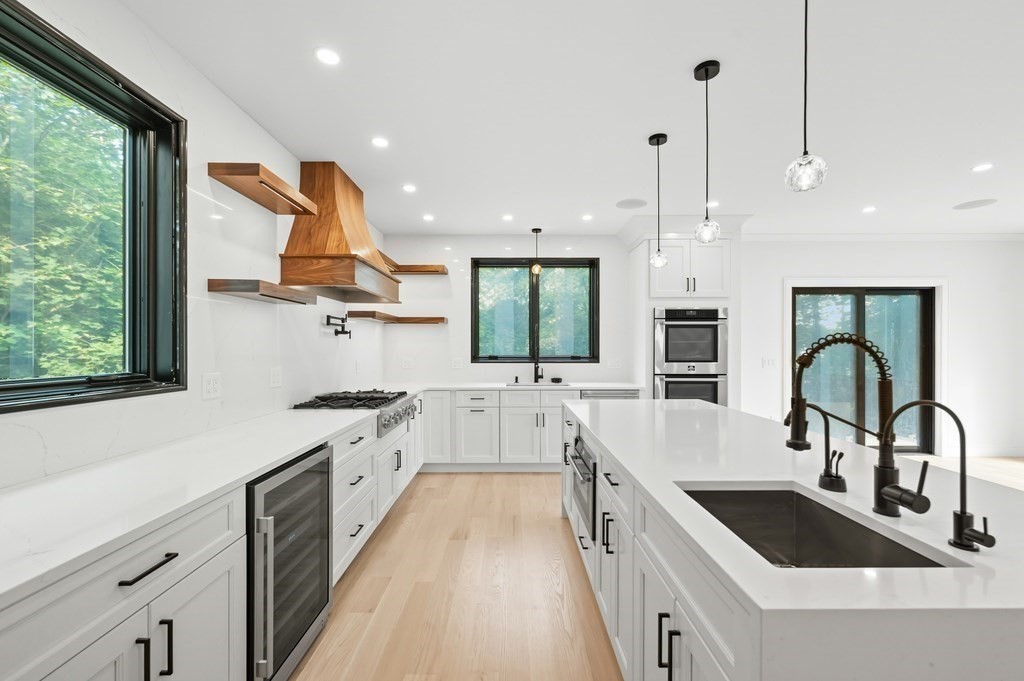 863 Main Street Reading, MA 01867 - Photo 7 of 42 a kitchen with counter top space a sink stainless steel appliances and windows