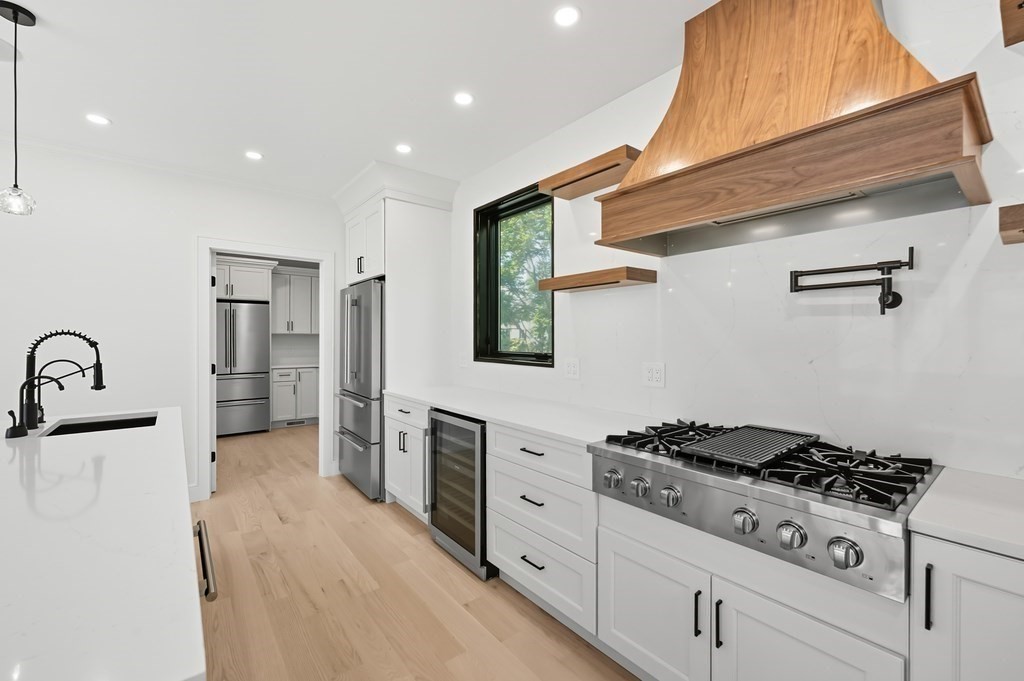 863 Main Street Reading, MA 01867 - Photo 9 of 42 a kitchen with stainless steel appliances granite countertop a stove and a refrigerator