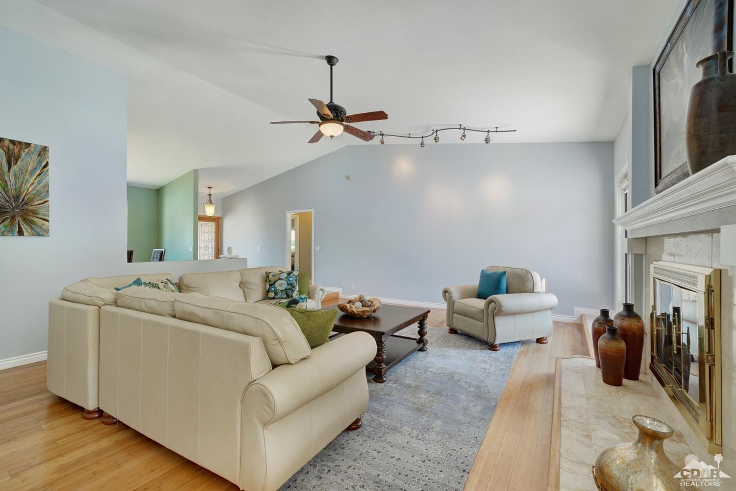 72671 Homestead Road Palm Desert, CA 92260 - Photo 11 of 39 a living room with furniture and a fireplace