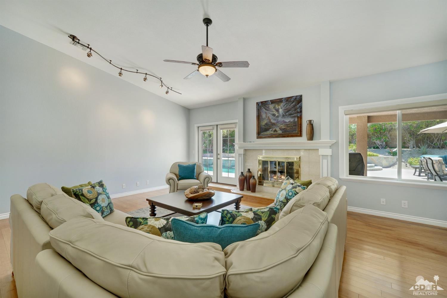 72671 Homestead Road Palm Desert, CA 92260 - Photo 12 of 39 a living room with furniture fireplace and a flat screen tv