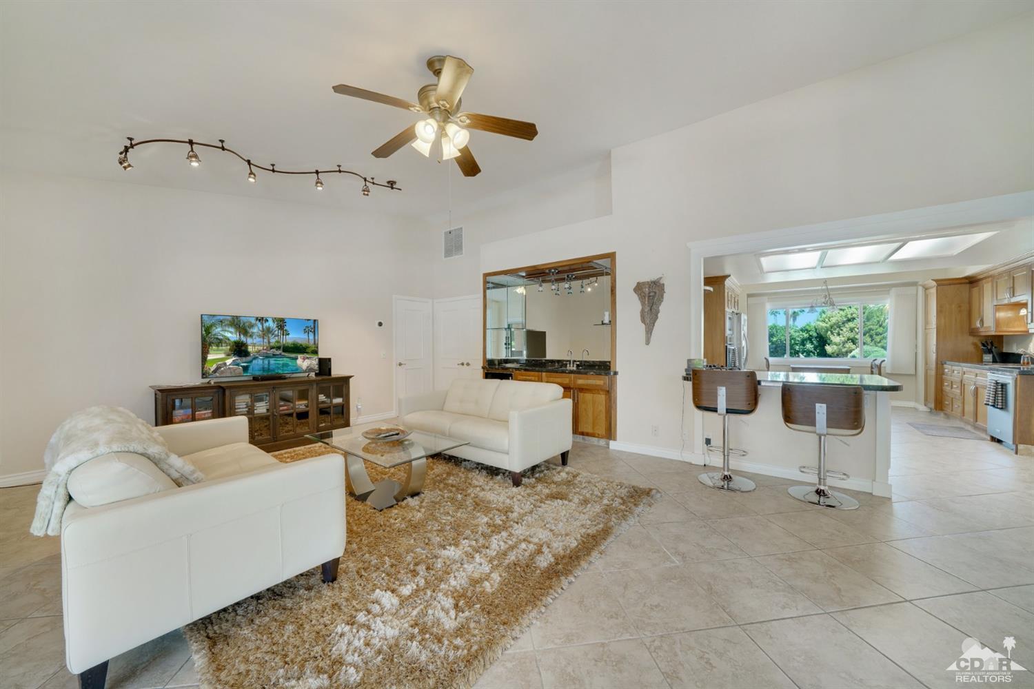 72671 Homestead Road Palm Desert, CA 92260 - Photo 13 of 39 a living room with furniture and a chandelier