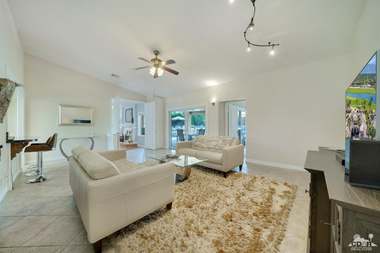 72671 Homestead Road Palm Desert, CA 92260 - Photo 15 of 39 a living room with furniture flat screen tv and a window