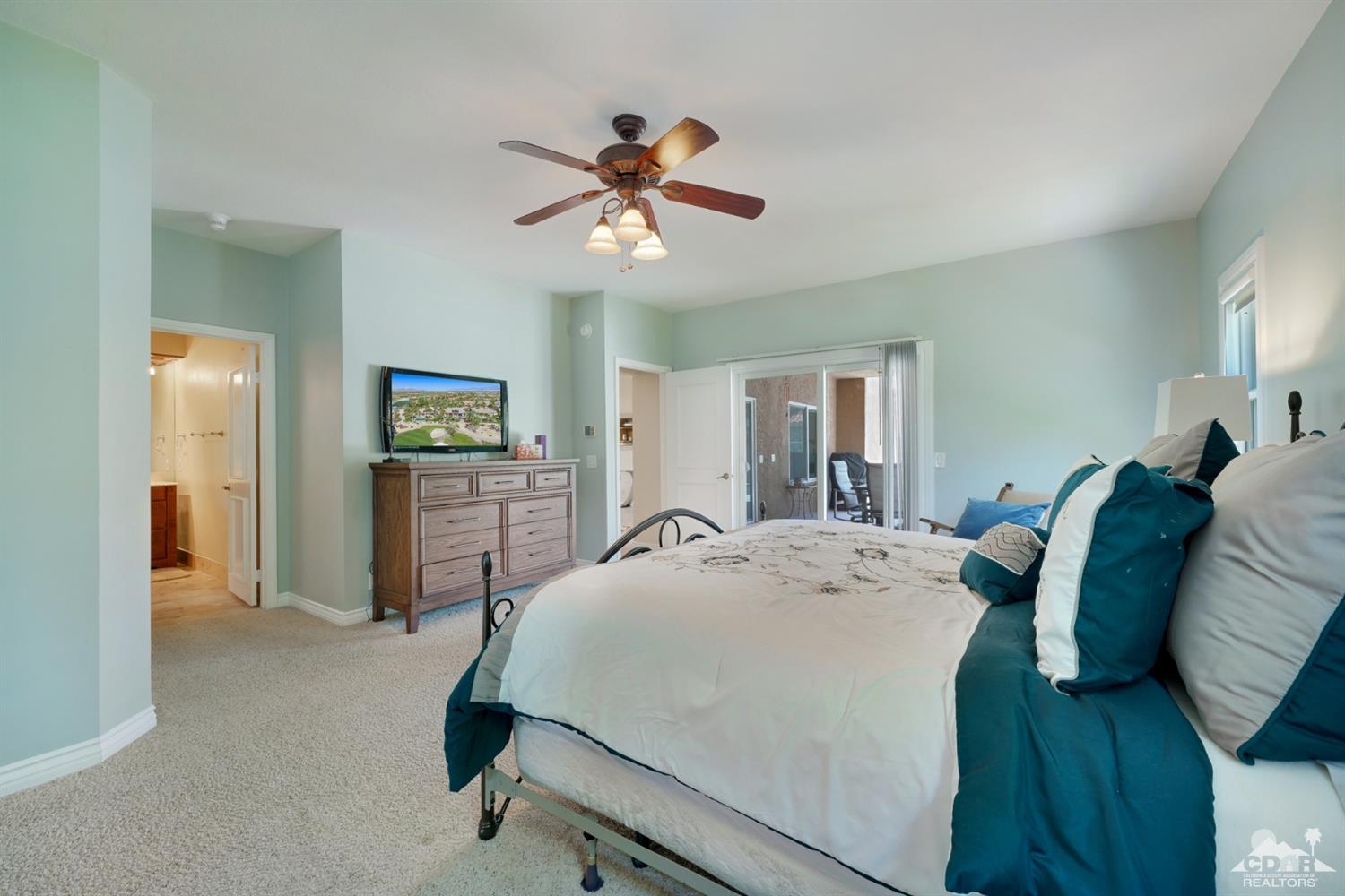 72671 Homestead Road Palm Desert, CA 92260 - Photo 22 of 39 a bed room with a bed and a chandelier