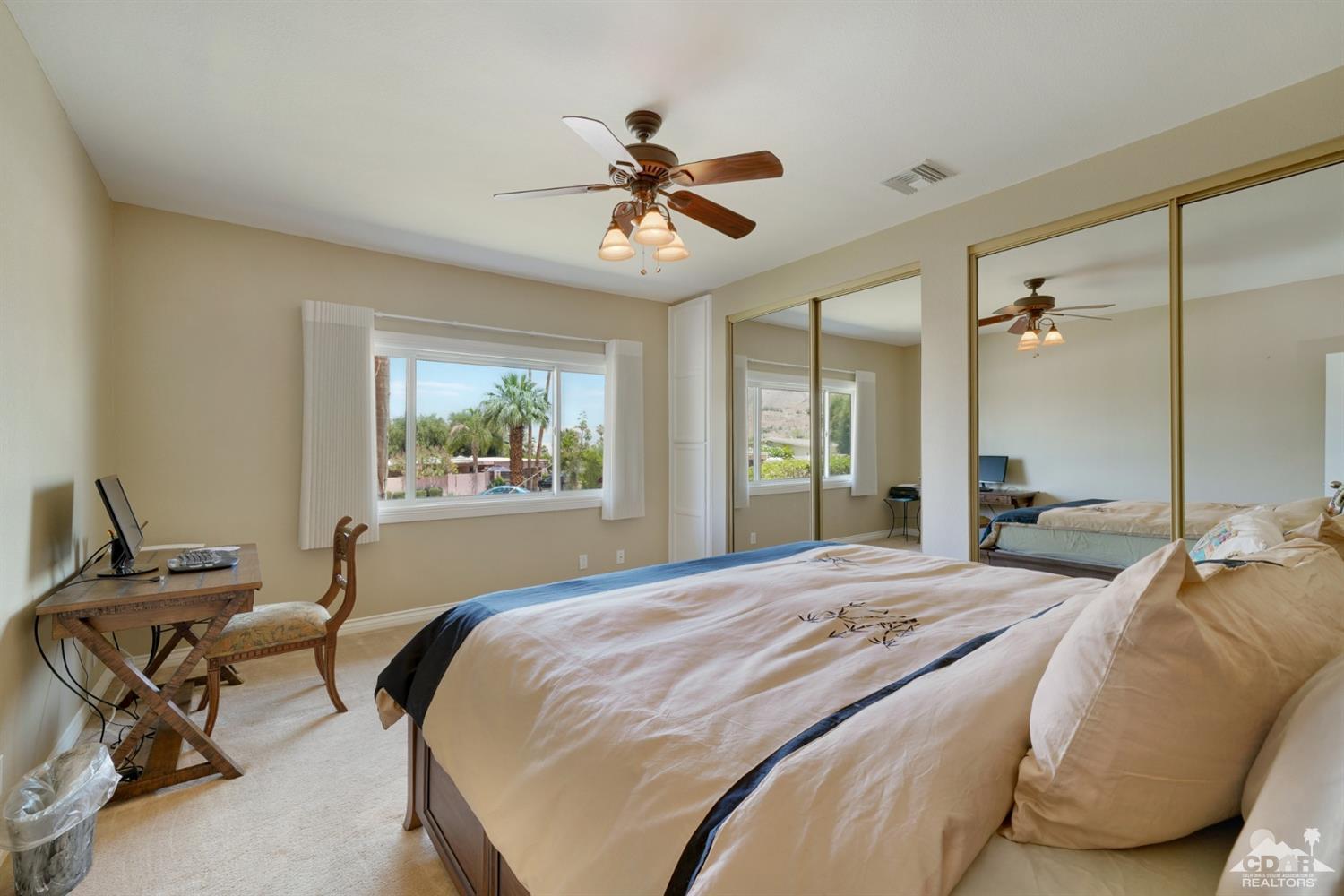 72671 Homestead Road Palm Desert, CA 92260 - Photo 24 of 39 a bedroom with a bed and a chandelier