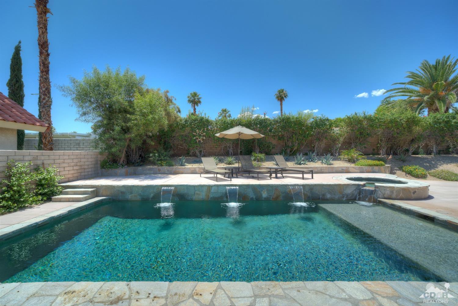 72671 Homestead Road Palm Desert, CA 92260 - Photo 30 of 39 a view of a swimming pool with a yard