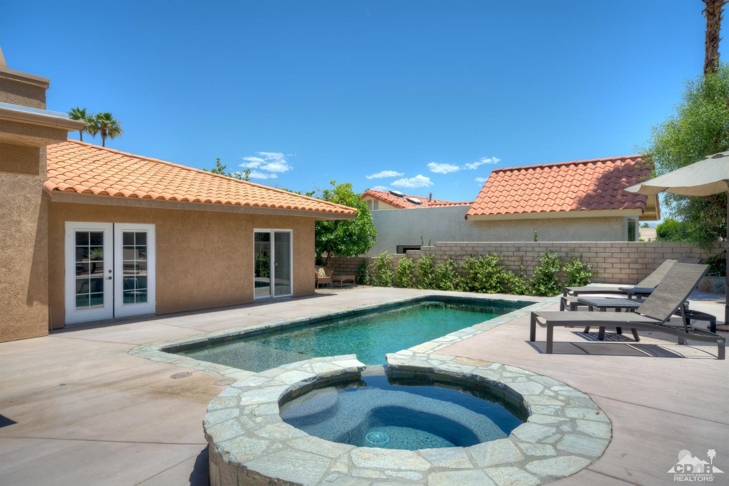 72671 Homestead Road Palm Desert, CA 92260 - Photo 35 of 39 a view of a house with backyard sitting area and swimming pool