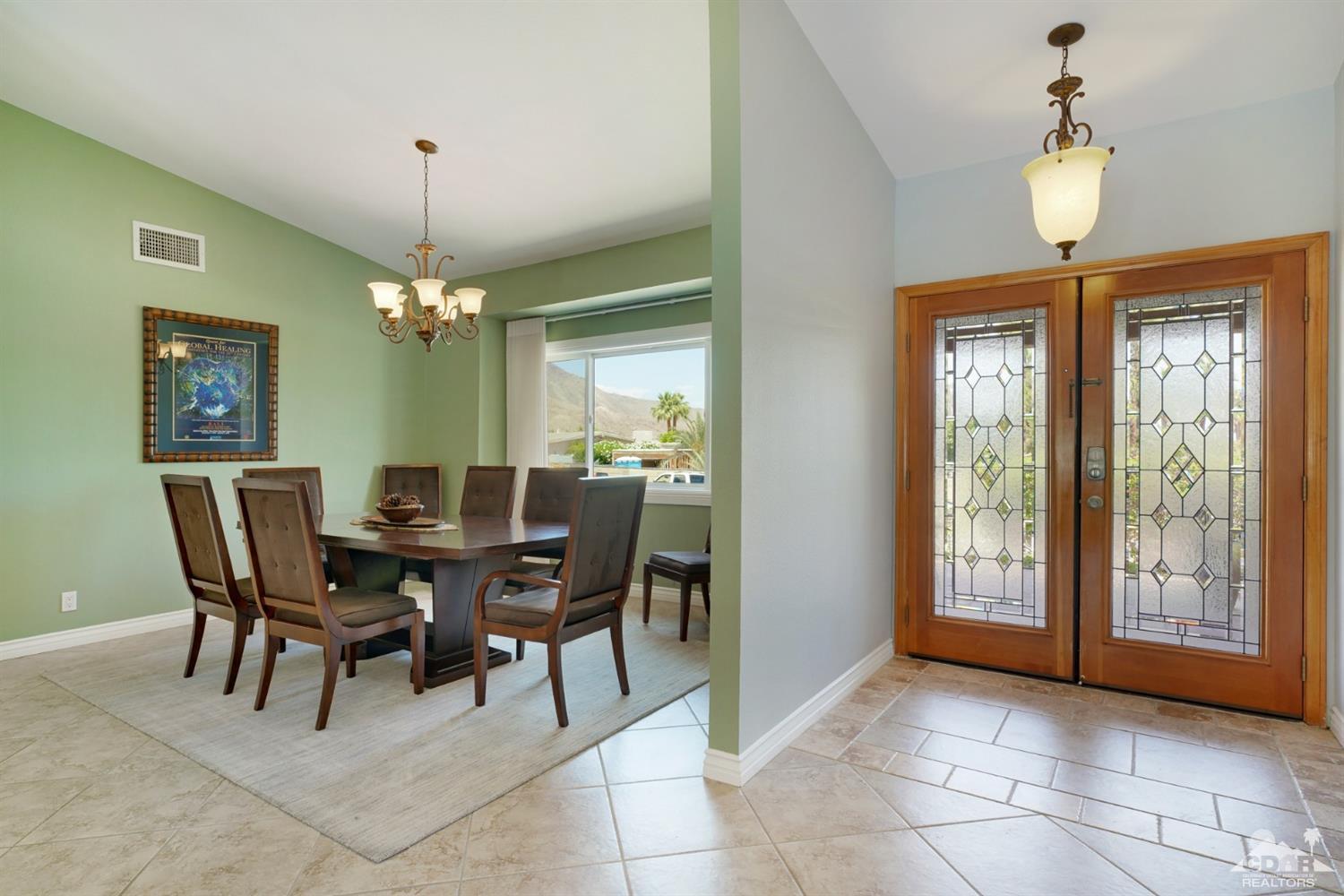 72671 Homestead Road Palm Desert, CA 92260 - Photo 6 of 39 a view of a dining room with furniture and chandelier