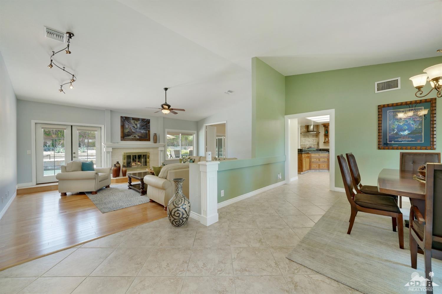 72671 Homestead Road Palm Desert, CA 92260 - Photo 7 of 39 a living room with furniture and a chandelier