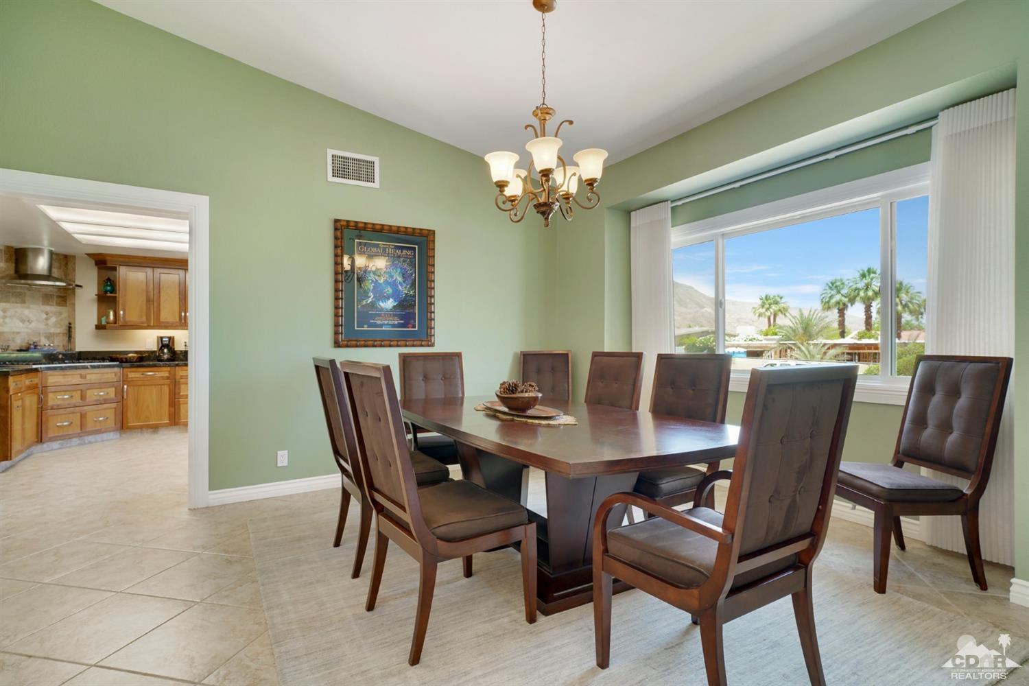 72671 Homestead Road Palm Desert, CA 92260 - Photo 8 of 39 a view of a dining room with furniture window and wooden floor