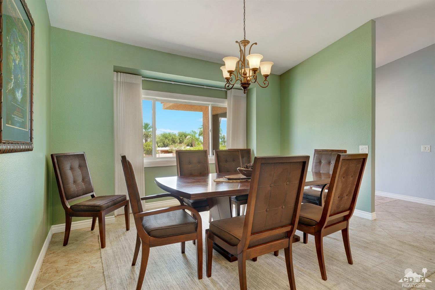 72671 Homestead Road Palm Desert, CA 92260 - Photo 9 of 39 a view of a dining room with furniture window and outside view