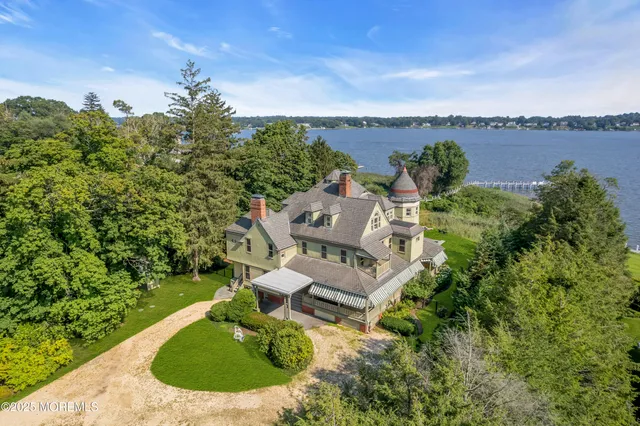 a living room with furniture a large window and a fireplace