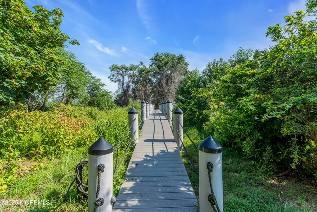 a kitchen with stainless steel appliances granite countertop a sink and wooden cabinets