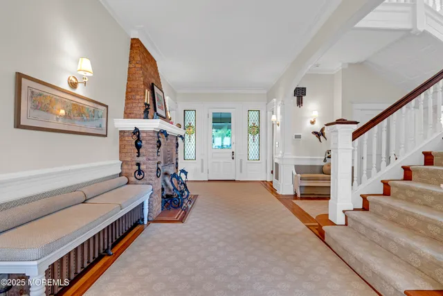 a living room with furniture and a baby crib