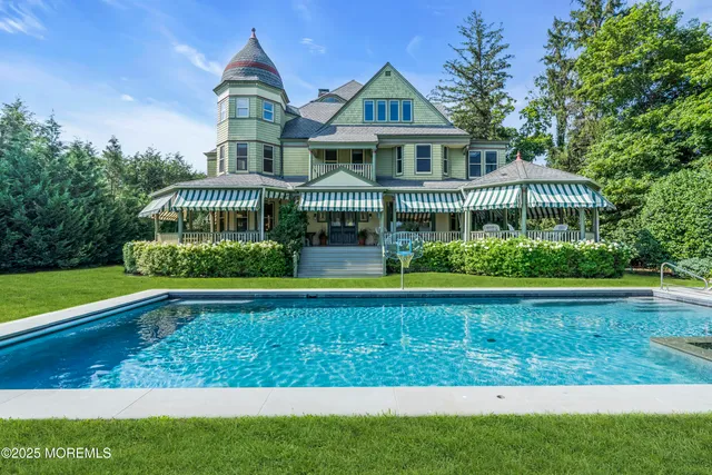 a view of a house with a yard and lake view
