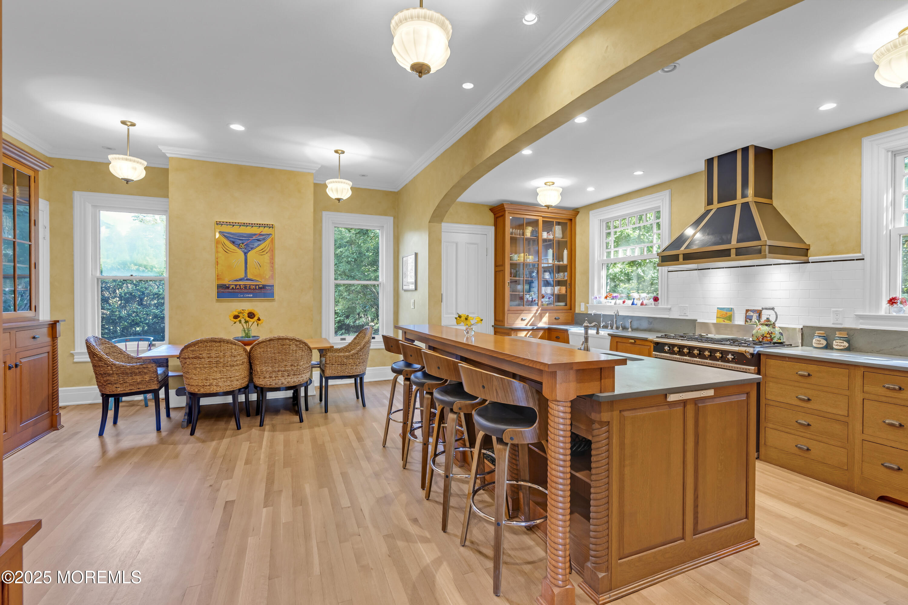 458 Navesink River Road Red Bank, NJ 07701 - Photo 45 of 118 a open kitchen with stainless steel appliances granite countertop a stove top oven a sink dishwasher a dining table and chairs with wooden floor