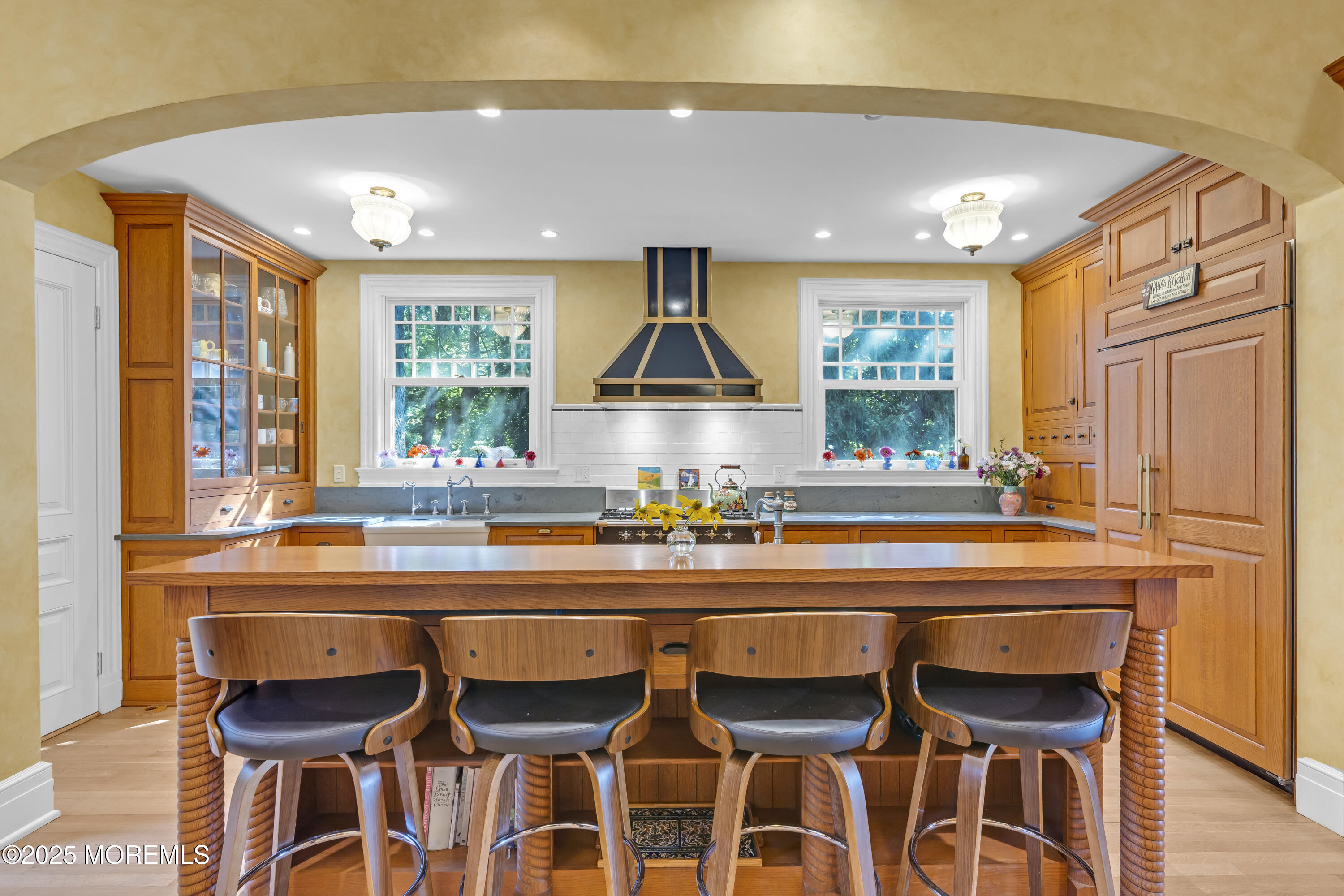 458 Navesink River Road Red Bank, NJ 07701 - Photo 46 of 118 a kitchen with a dining table chairs cabinets and stainless steel appliances