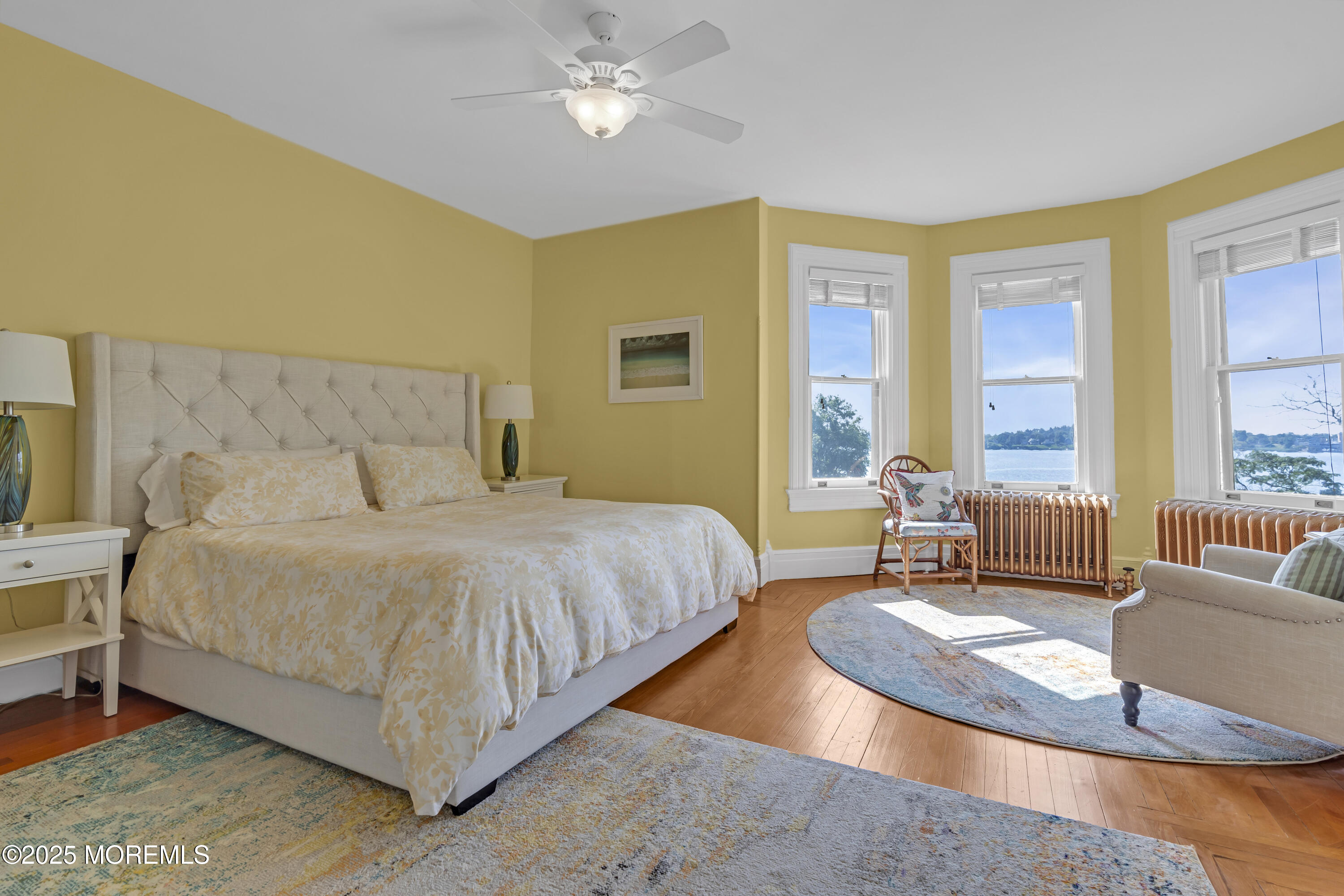 458 Navesink River Road Red Bank, NJ 07701 - Photo 74 of 118 a spacious bedroom with a bed a couch and a large window