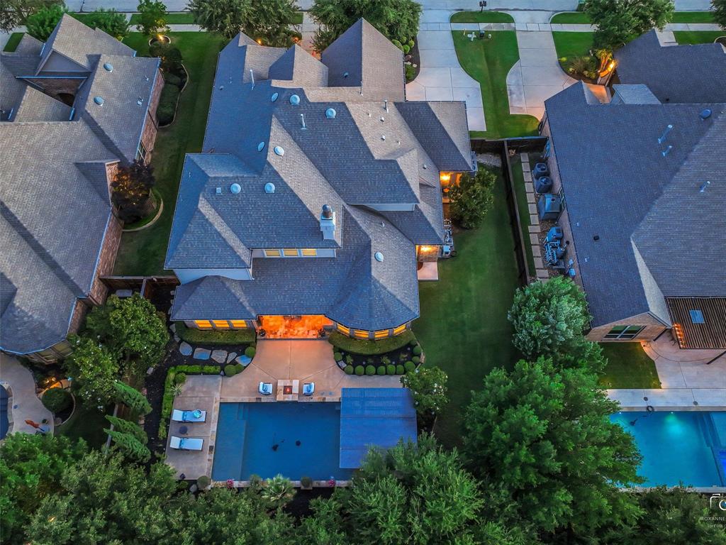 3117 Callander The Colony, TX 75056 - Photo 2 of 40 Resort like backyard with LARGE grassy area covered pergola, firepit and pool with sundeck and rain curtain. Pergola has built in heater for year around use.