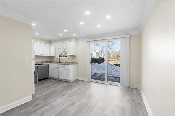 a kitchen with a white stove top oven and kitchen island