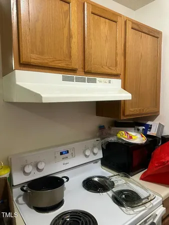 a room with a stove and a cabinet