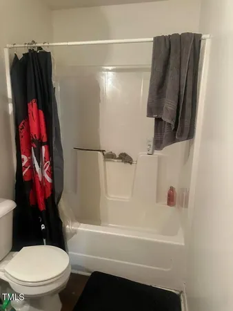 a bathroom with a shower and a toilet