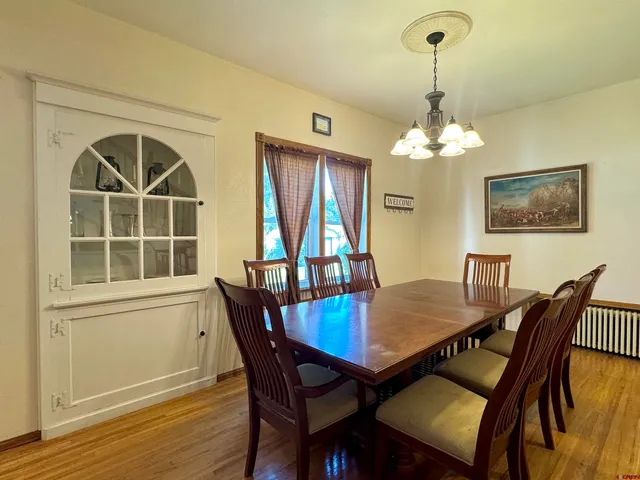 a view of a dining room with furniture window and wooden floor