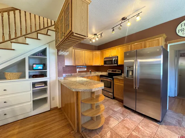 a kitchen with cabinets and stainless steel appliances