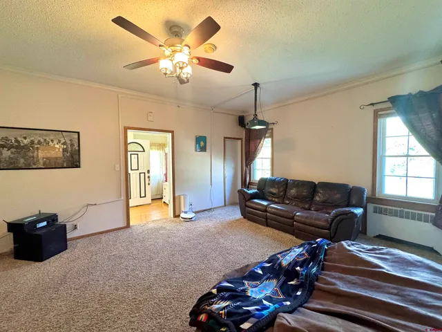a living room with furniture a chandelier and a window