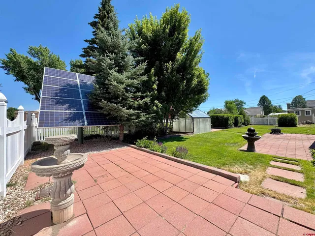 a view of a backyard with sitting area