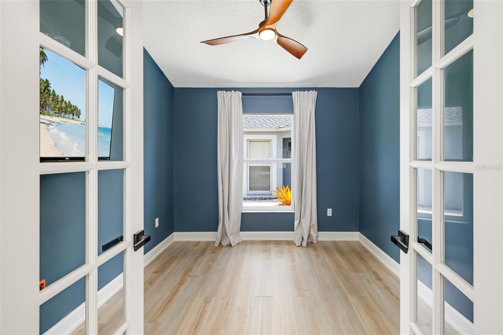 6226 Blueflower Court Lakewood Ranch, FL 34202 - Photo 13 of 81 a view of empty room with wooden floor