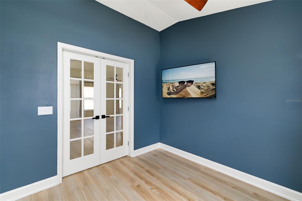 6226 Blueflower Court Lakewood Ranch, FL 34202 - Photo 14 of 81 a view of an empty room with wooden floor and a window