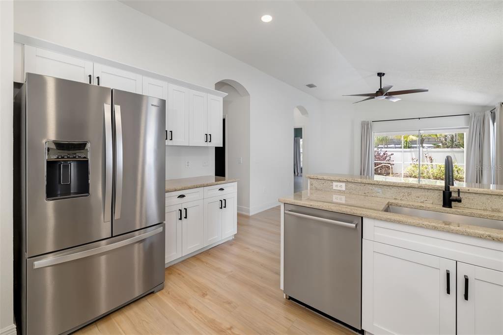 6226 Blueflower Court Lakewood Ranch, FL 34202 - Photo 18 of 81 a kitchen with stainless steel appliances a refrigerator sink and cabinets