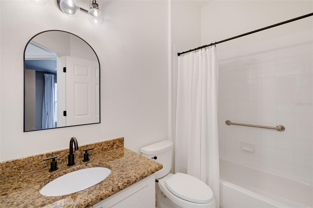 6226 Blueflower Court Lakewood Ranch, FL 34202 - Photo 23 of 81 a bathroom with a granite countertop sink toilet and shower