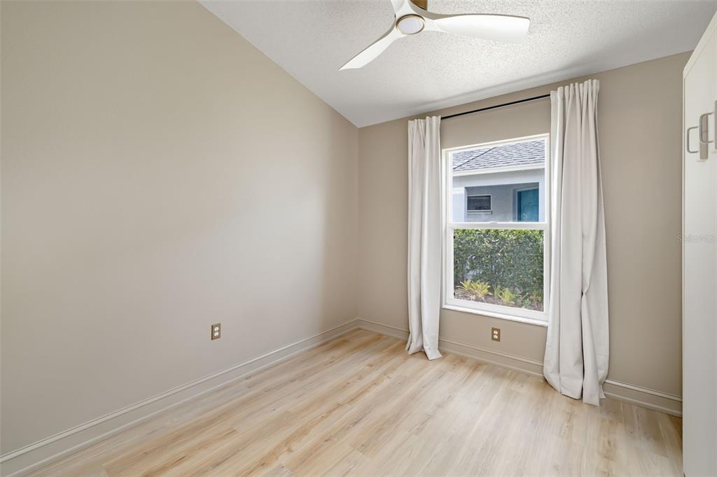 6226 Blueflower Court Lakewood Ranch, FL 34202 - Photo 24 of 81 an empty room with a window and wooden floor
