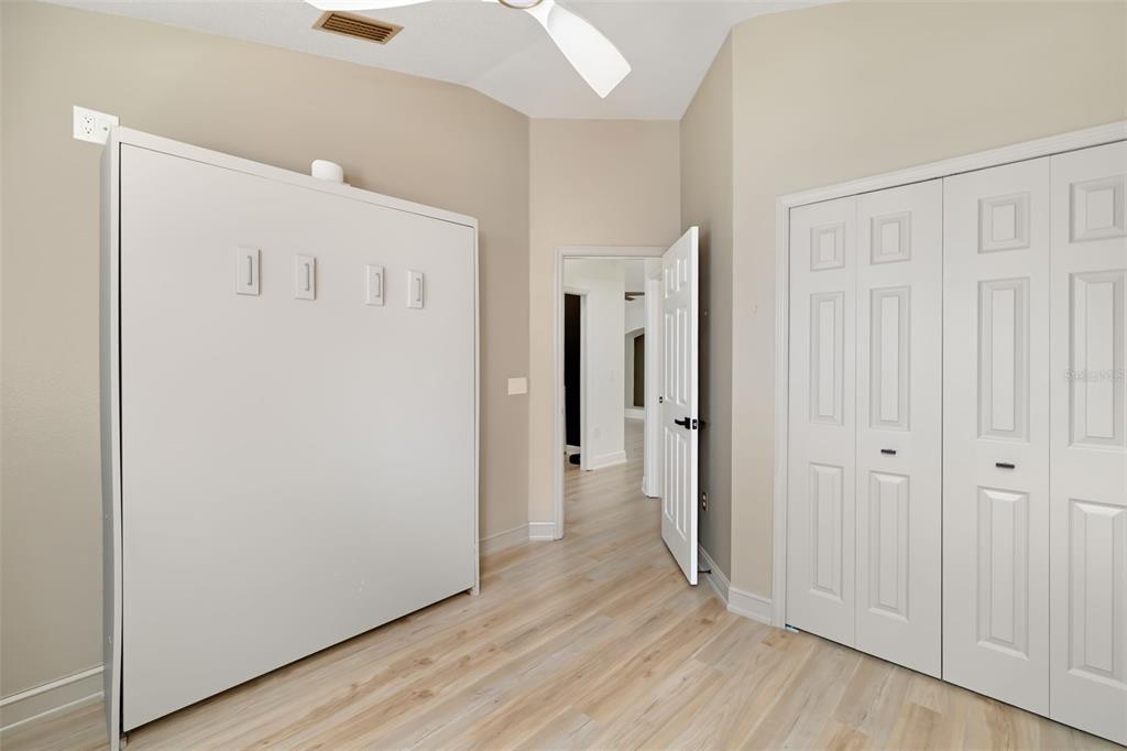 6226 Blueflower Court Lakewood Ranch, FL 34202 - Photo 25 of 81 a view of a hallway with wooden floor