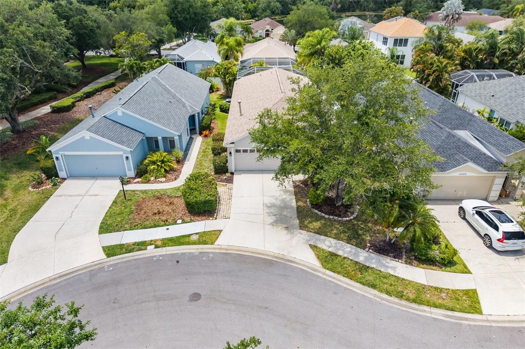 6226 Blueflower Court Lakewood Ranch, FL 34202 - Photo 43 of 81 an aerial view of a house with a yard and greenery