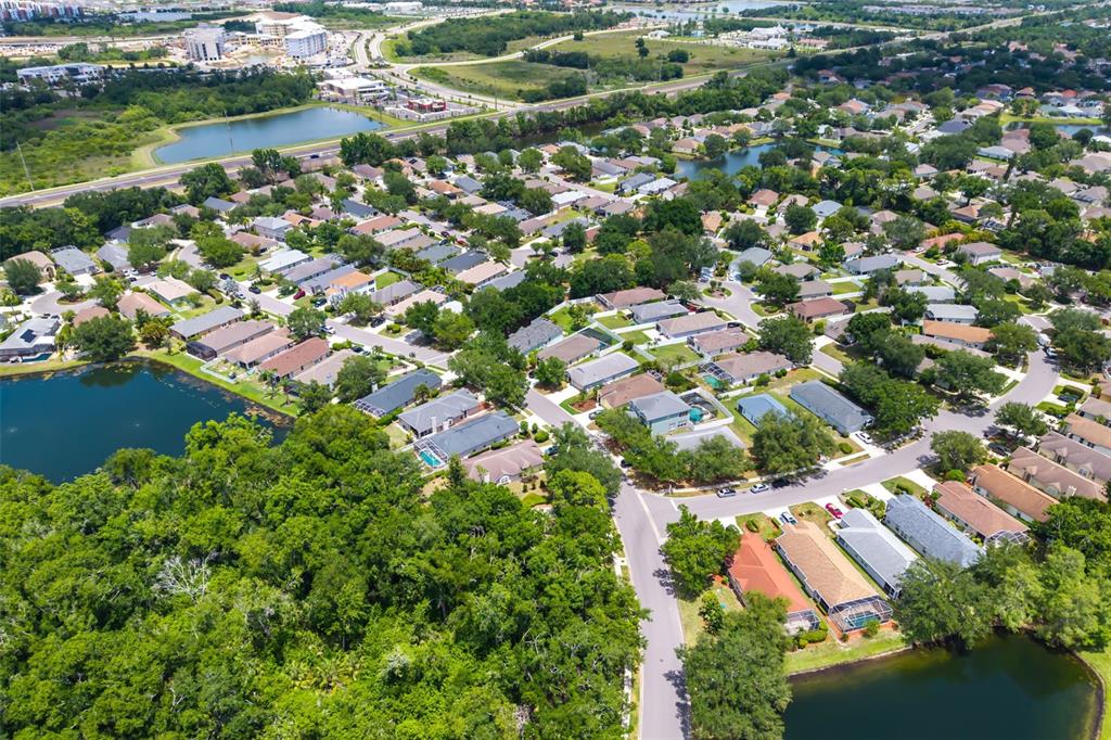 6226 Blueflower Court Lakewood Ranch, FL 34202 - Photo 49 of 81 an aerial view of residential houses with outdoor space and trees